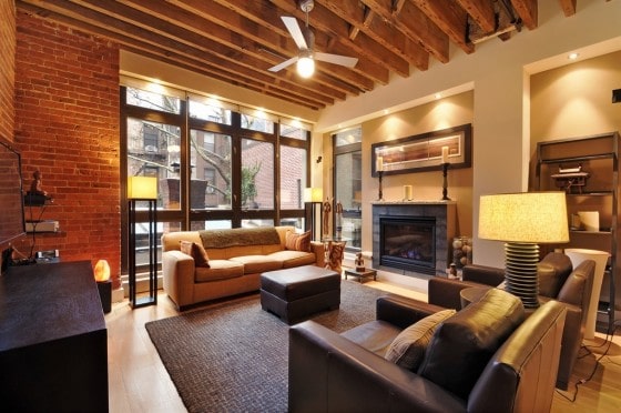 Diseño de apartamento con chimenea y elementos de madera y ladrillo