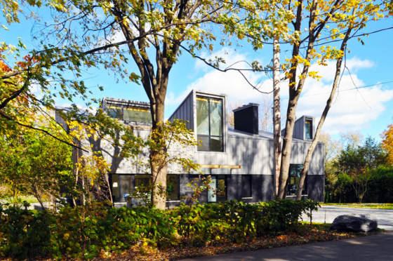 Fachada de casa autosustentable con grandes ventanas 