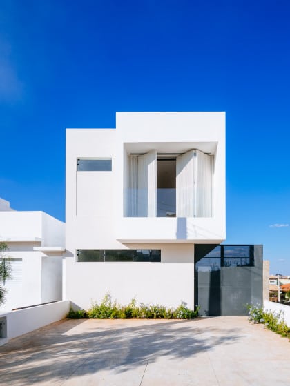 Sencilla casa de dos pisos construida en terreno pequeño, diseño minimalista en fachada e interiores