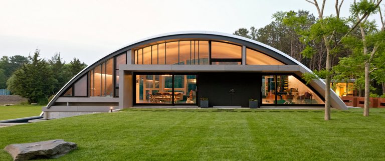 Diseño de casa moderna en forma de arco, construcción integrada al entorno natural con arquitectura paisajista